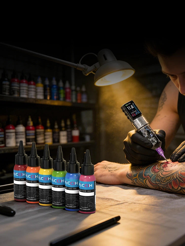 A tattoo artist wearing black gloves applies ink to a client's tattooed arm using a tattoo machine, with a row of HSC brand ink bottles lined up on the table in the foreground under a bright work light.