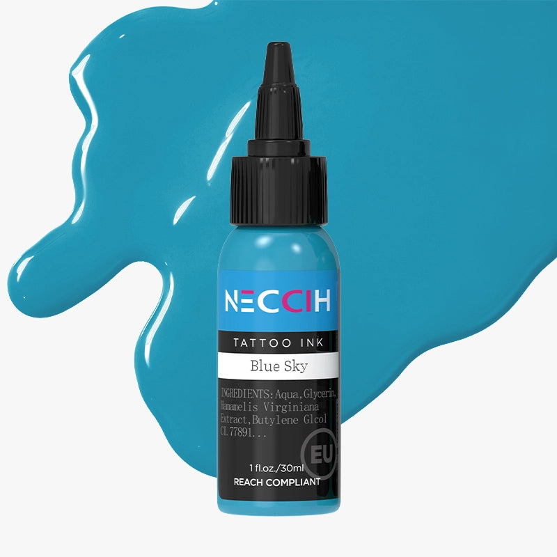 A 1 fl oz bottle of NECOH Tattoo Ink in the shade Blue Sky, shown with a black cap and surrounded by blue liquid splashes on a light gray background.