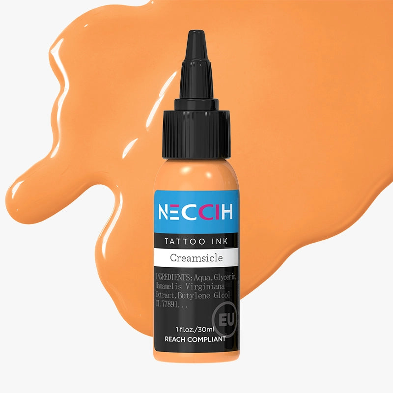 A bottle of NECCH Tattoo Ink in the shade Creamsicle, shown against a light gray background with a large, glossy orange paint smear behind it.